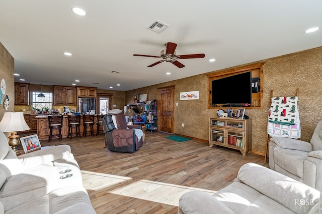 living room featuring hardwood / wood-style flooring and ceiling fan