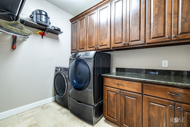 laundry area featuring cabinets and washer and clothes dryer