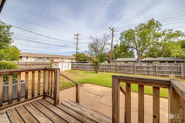 2501 Tcu Ave, San Angelo, TX 76904 - deck with a fenced backyard, a storage unit, and a patio area