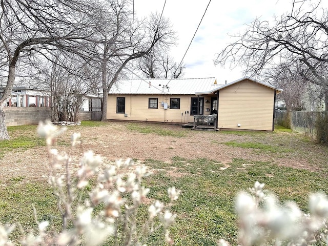 rear view of property with a yard