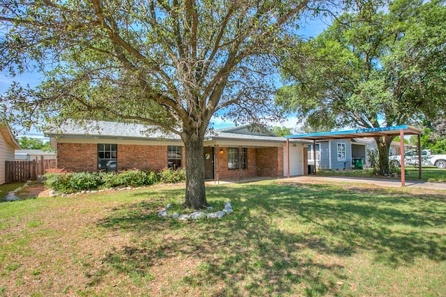 119 Van Zandt St, San Angelo, TX 76905 - ranch-style home featuring brick siding, a garage, concrete driveway, and an attached carport