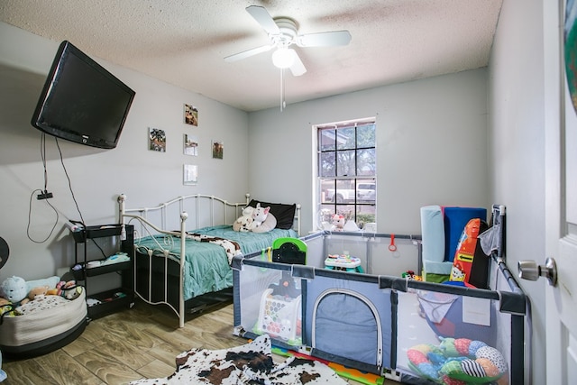 119 Van Zandt St, San Angelo, TX 76905 - bedroom with wood finished floors, a textured ceiling, and ceiling fan