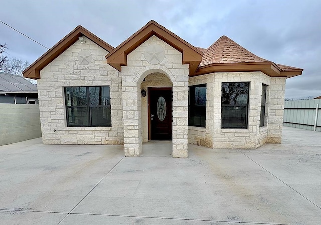 2110 Shelton St, San Angelo, TX 76903 - view of front of property with stone siding and roof with shingles