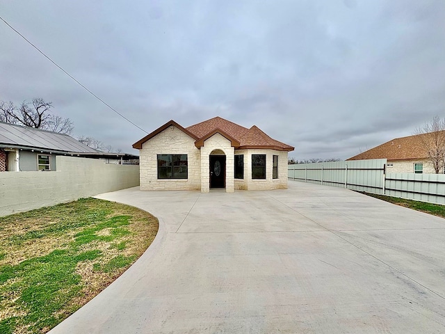 2110 Shelton St, San Angelo, TX 76903 - view of front of property with stone siding and a patio