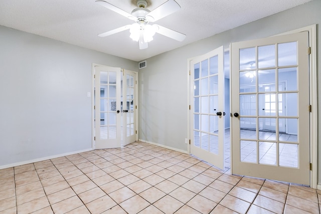 entryway with a textured ceiling, visible vents, baseboards, a ceiling fan, and french doors