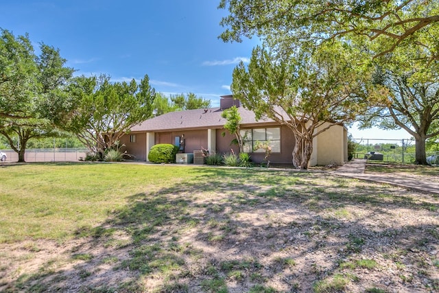 view of front of property featuring stucco siding, fence, and a front yard