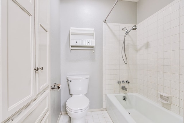 bathroom featuring baseboards, shower / bath combination, toilet, and tile patterned floors