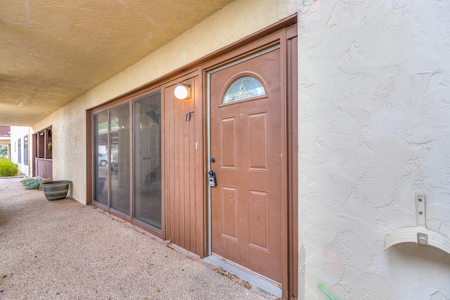 doorway to property with stucco siding