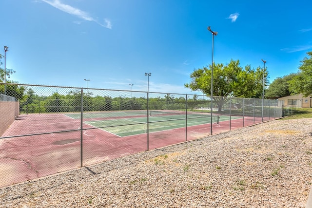 view of sport court featuring fence