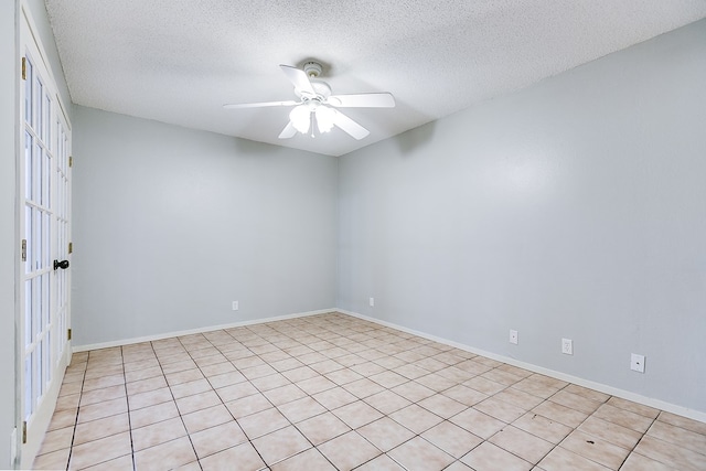 unfurnished room with a ceiling fan, a textured ceiling, and baseboards