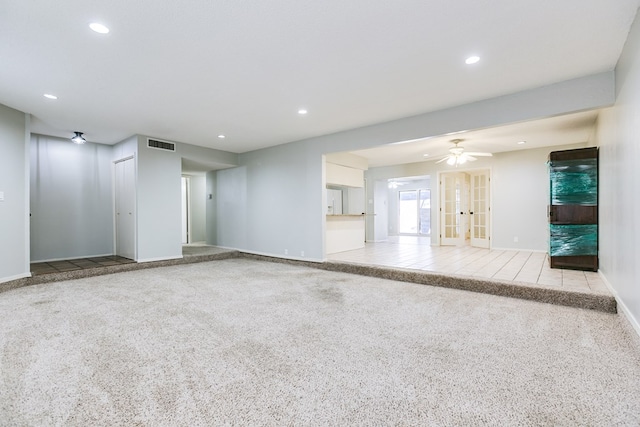 unfurnished living room with baseboards, carpet floors, visible vents, and recessed lighting