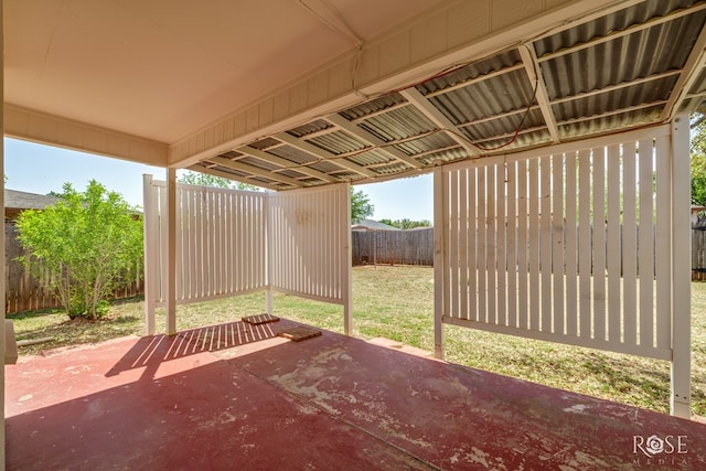 view of patio / terrace with a fenced backyard and a carport