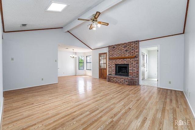 unfurnished living room featuring visible vents, a fireplace, wood finished floors, baseboards, and ceiling fan with notable chandelier