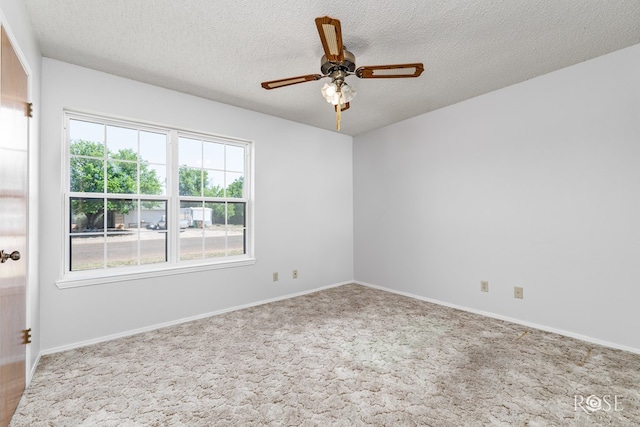 carpeted empty room with baseboards, a textured ceiling, and ceiling fan