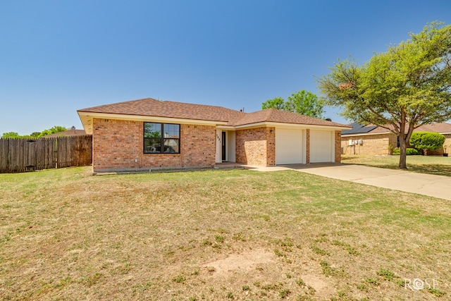 single story home with a garage, a front lawn, fence, brick siding, and concrete driveway