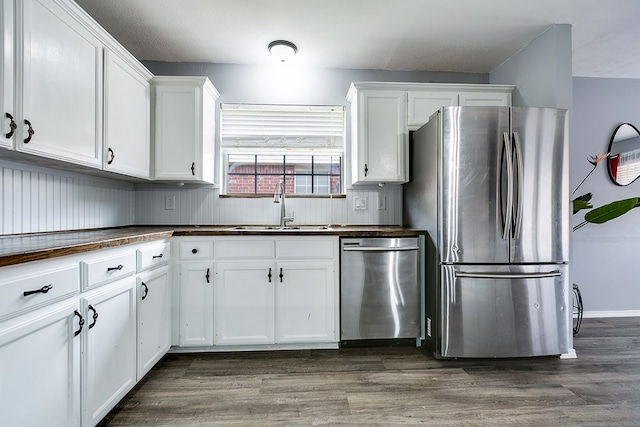 kitchen with white cabinetry, appliances with stainless steel finishes, sink, and dark wood-type flooring