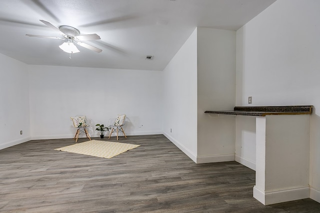 unfurnished room with dark hardwood / wood-style flooring and ceiling fan