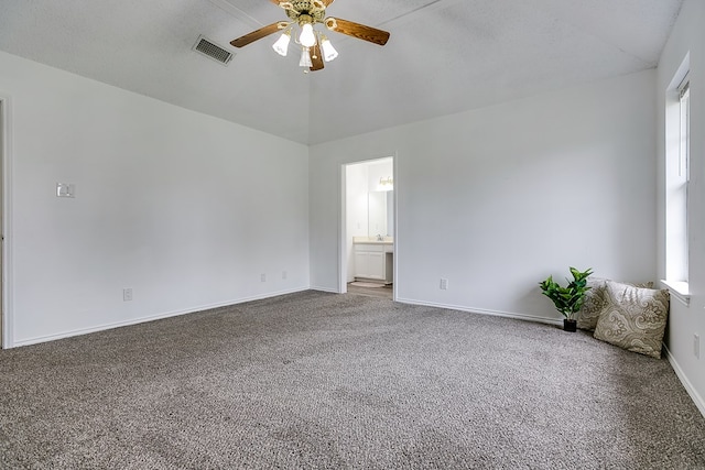 unfurnished room featuring carpet, plenty of natural light, a textured ceiling, and ceiling fan