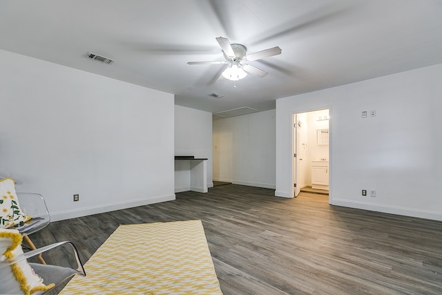 living room featuring dark wood-type flooring and ceiling fan