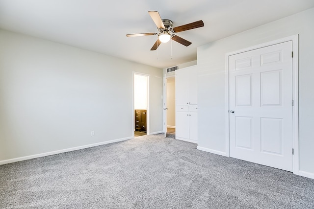 2729 Rio Grande St, San Angelo, TX 76904 - unfurnished bedroom with carpet, baseboards, a ceiling fan, and connected bathroom