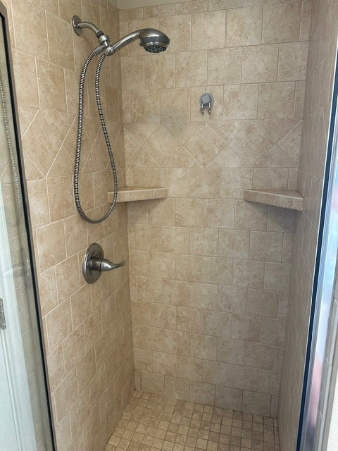 bathroom featuring a shower stall