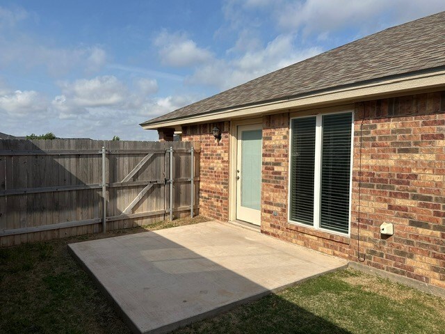view of patio featuring a gate and fence
