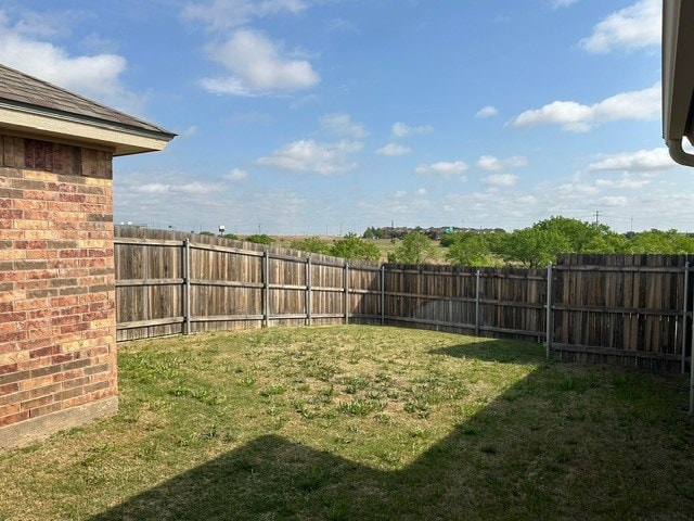 view of yard with a fenced backyard
