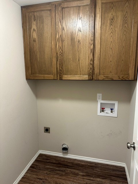 washroom featuring hookup for a washing machine, baseboards, electric dryer hookup, cabinet space, and dark wood-style flooring