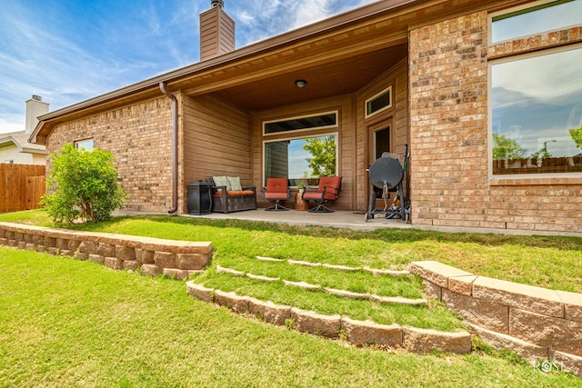 5922 Tarin St, San Angelo, TX 76904 - rear view of house with a patio area, a chimney, and brick siding