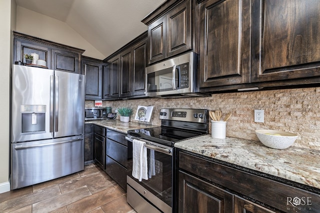 5922 Tarin St, San Angelo, TX 76904 - kitchen with stainless steel appliances, lofted ceiling, light stone counters, backsplash, and dark brown cabinetry