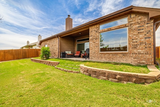 5922 Tarin St, San Angelo, TX 76904 - back of property featuring brick siding, a patio, and a chimney