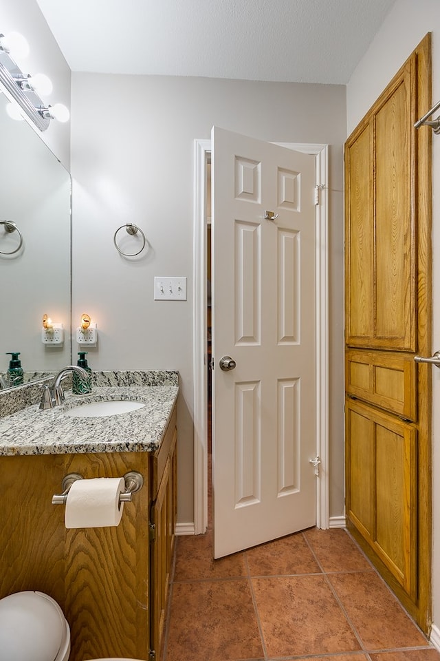 bathroom featuring tile patterned flooring and vanity