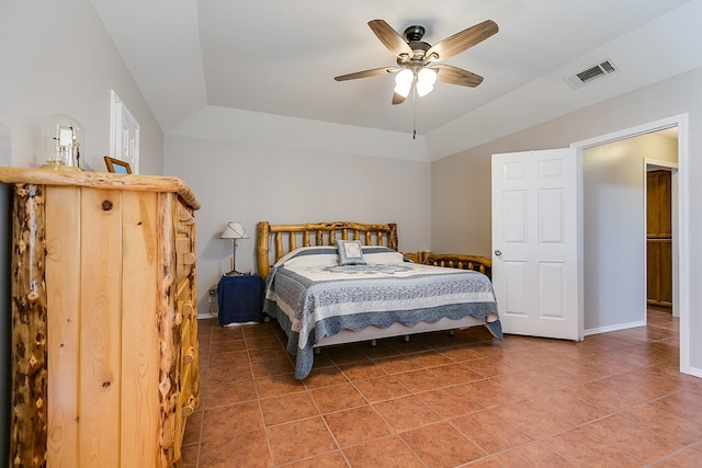 tiled bedroom with lofted ceiling and ceiling fan