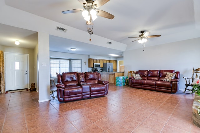 tiled living room with ceiling fan