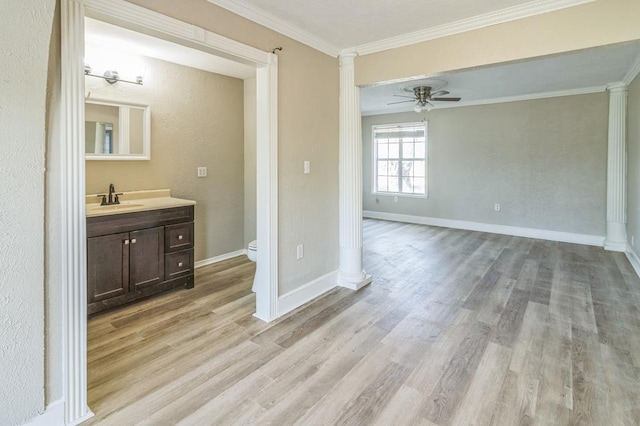 bathroom with crown molding, vanity, wood-type flooring, toilet, and ornate columns