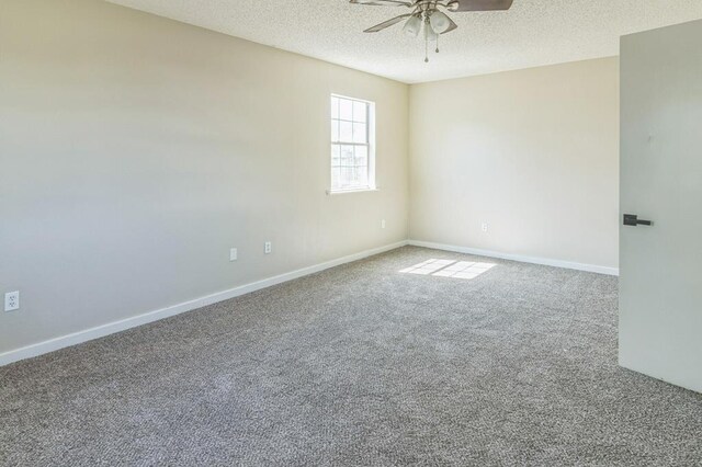 spare room with carpet, a textured ceiling, and ceiling fan