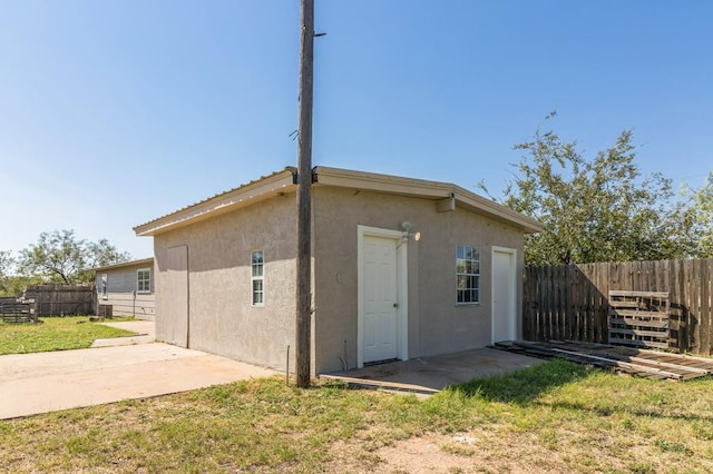 rear view of house with a yard and a patio area