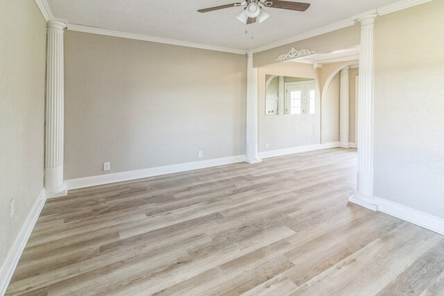 unfurnished room with ceiling fan, ornamental molding, decorative columns, and light wood-type flooring