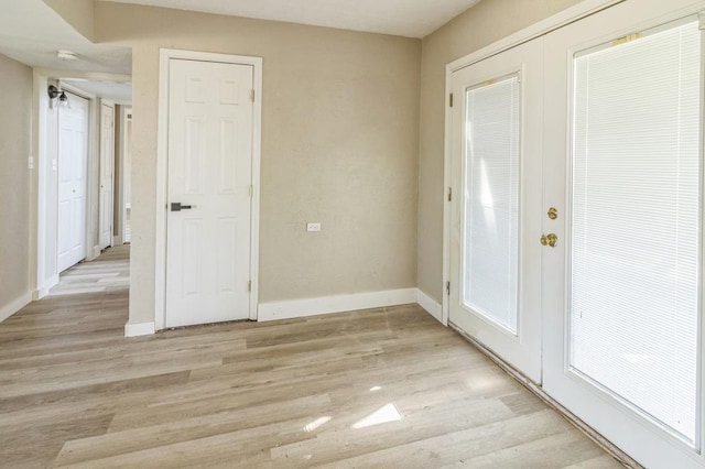 foyer entrance featuring french doors and light hardwood / wood-style flooring