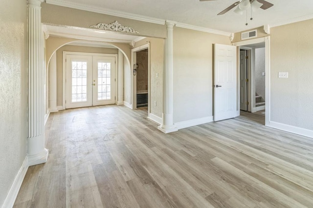 unfurnished living room featuring crown molding, light hardwood / wood-style flooring, decorative columns, and french doors