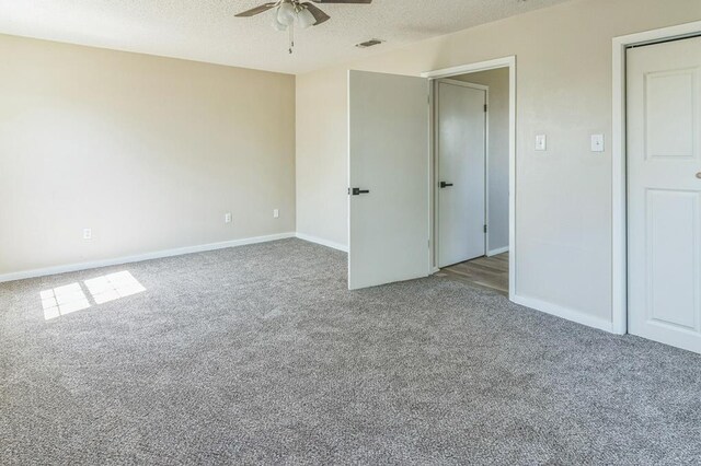 unfurnished room featuring carpet floors, a textured ceiling, and ceiling fan