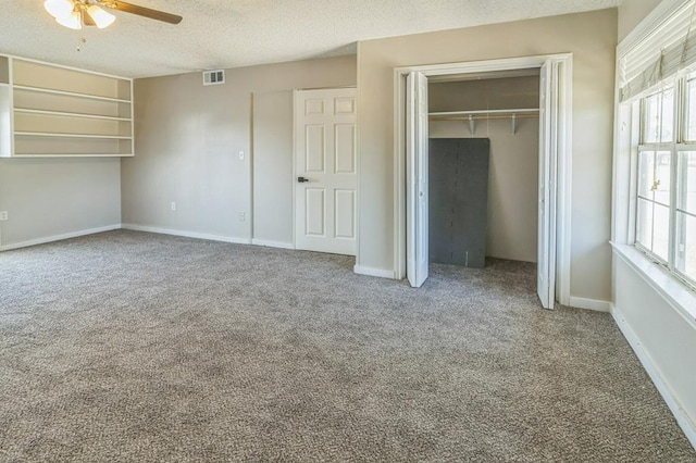 unfurnished bedroom featuring carpet floors, a textured ceiling, ceiling fan, and a closet