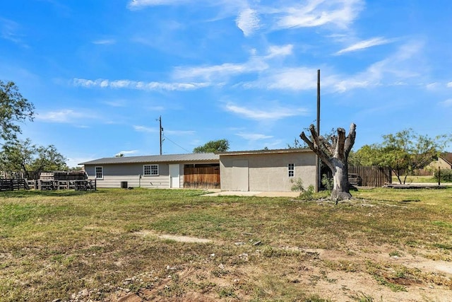 rear view of property with a yard