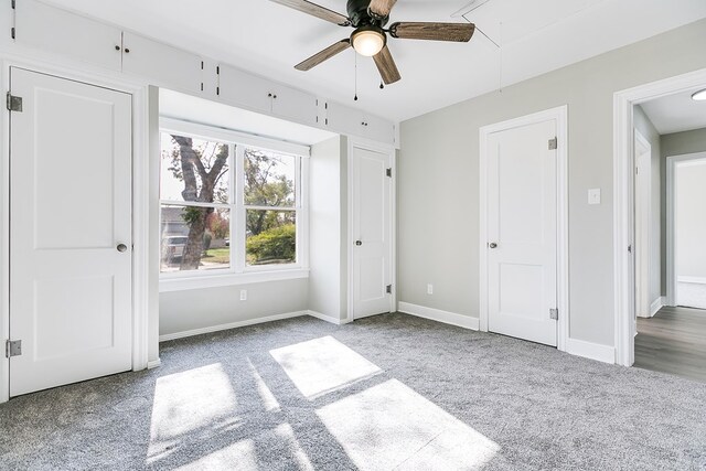 unfurnished bedroom featuring ceiling fan and carpet