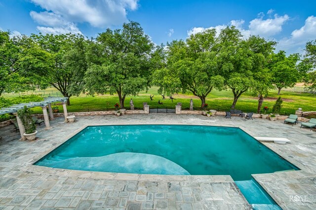 view of swimming pool with a pergola, a patio area, and a lawn