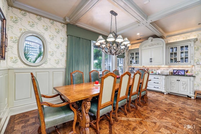 dining space with beamed ceiling, ornamental molding, a chandelier, and dark parquet floors