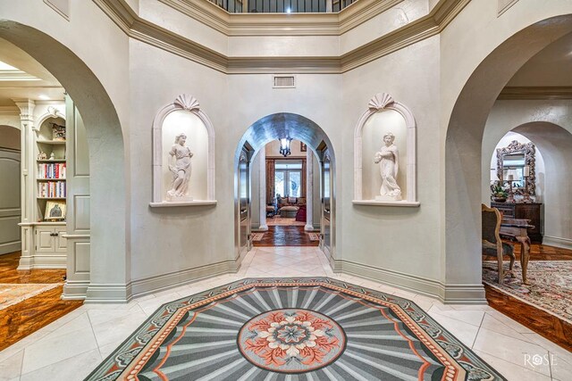 entryway featuring light tile patterned floors and a high ceiling