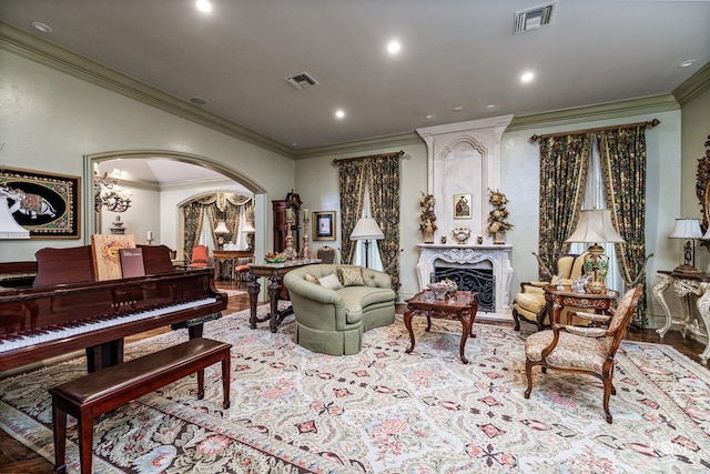 living area featuring ornamental molding, a premium fireplace, and light wood-type flooring