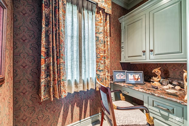 office area featuring built in desk and ornamental molding