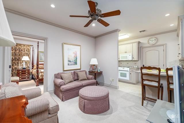 carpeted living room with crown molding and ceiling fan